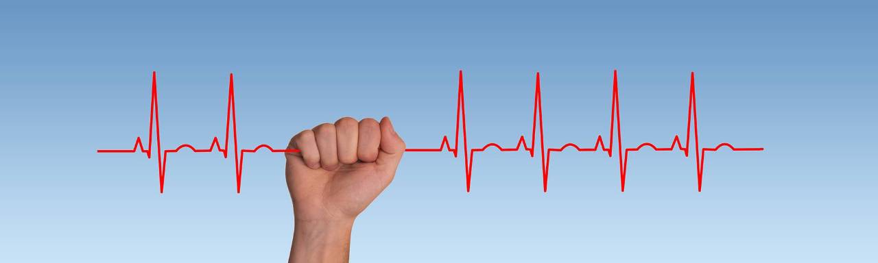 Hand gripping an cardiac graph
